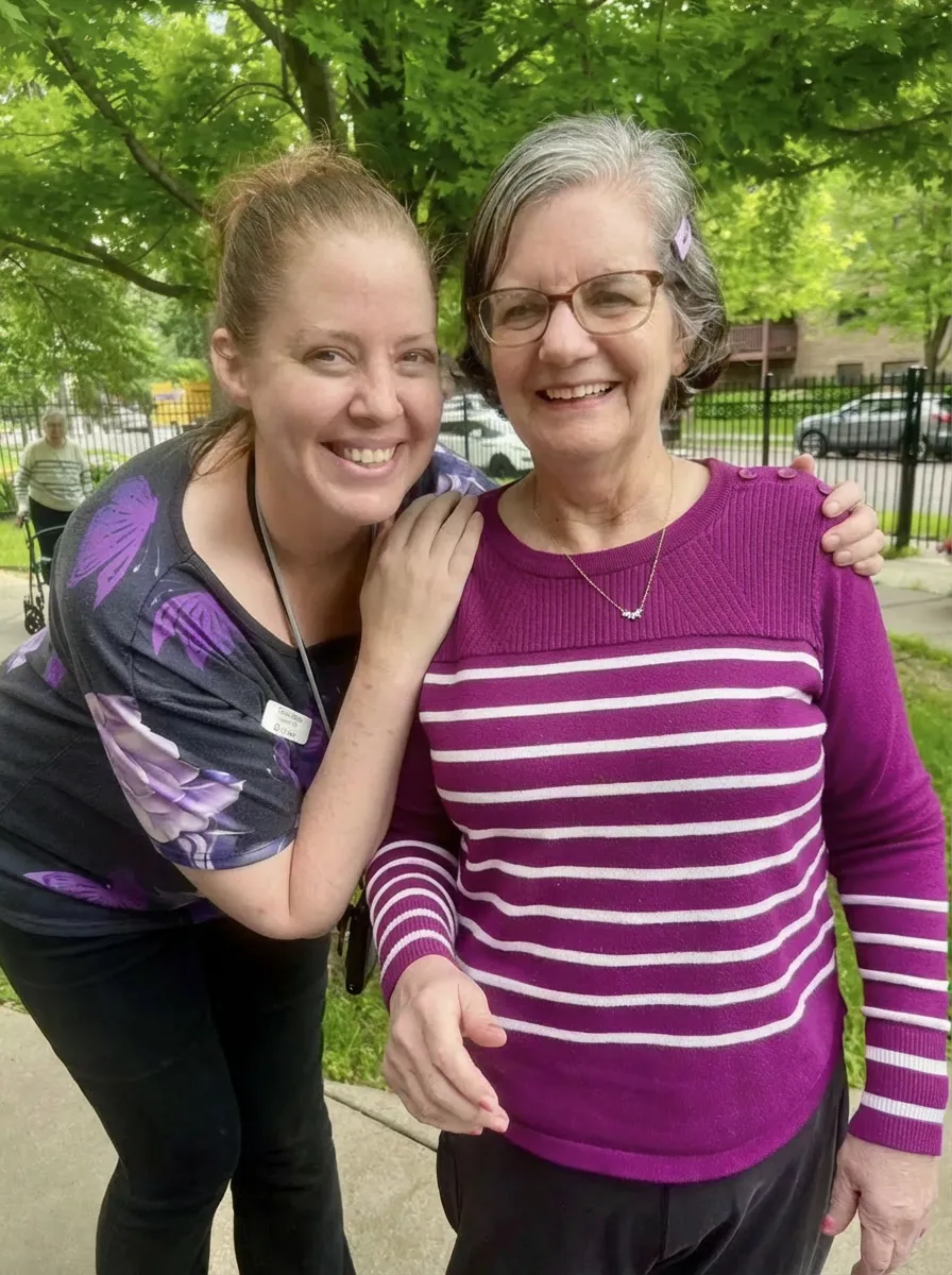 Compassionate staff member sharing a smile with a resident at The Alton